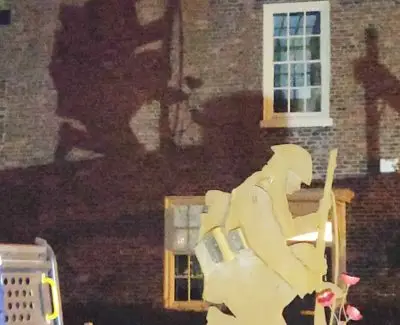 Unveiling of soldier the silhouette captured on the wall of a house during the unveiling